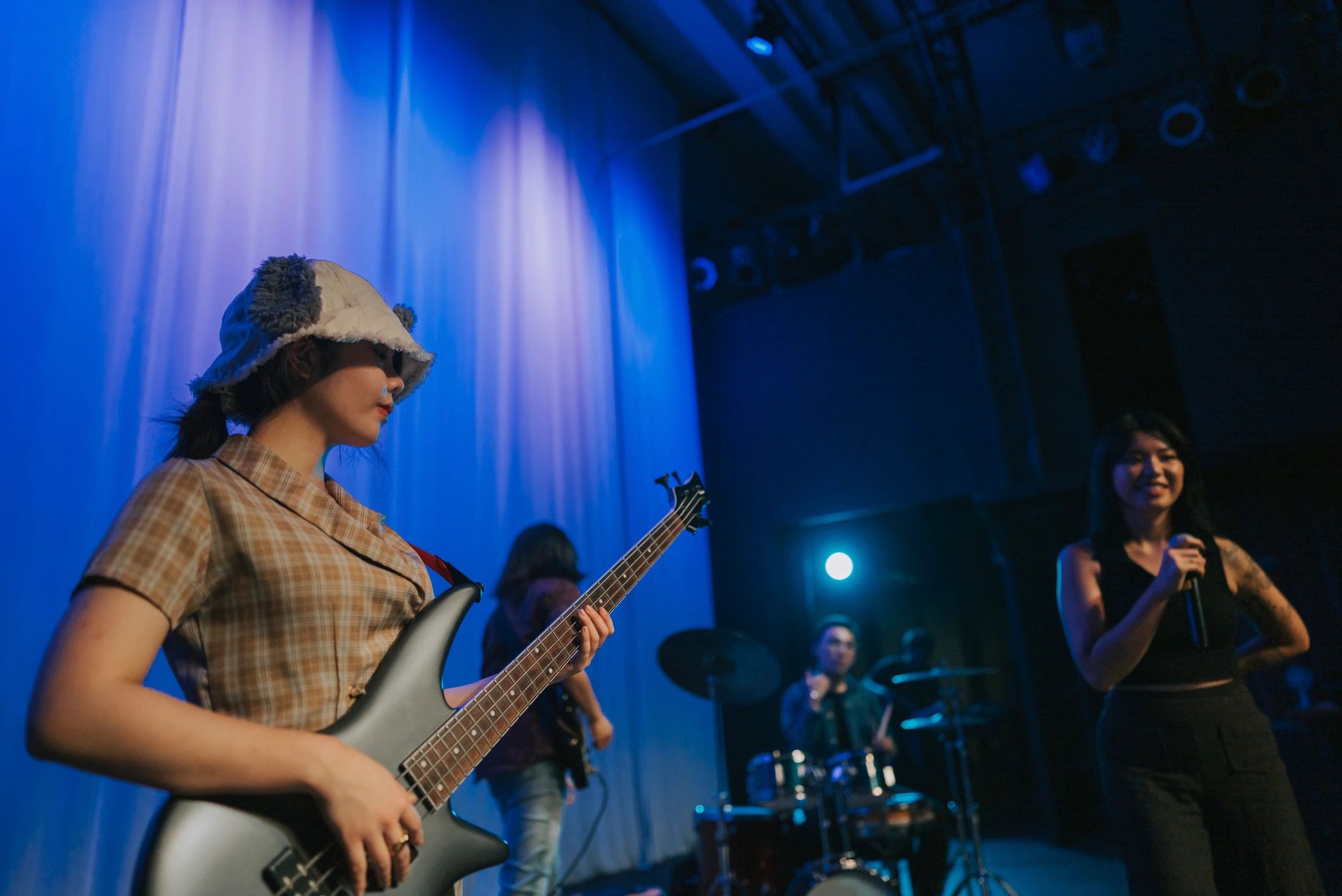 Band performing live under stage lights