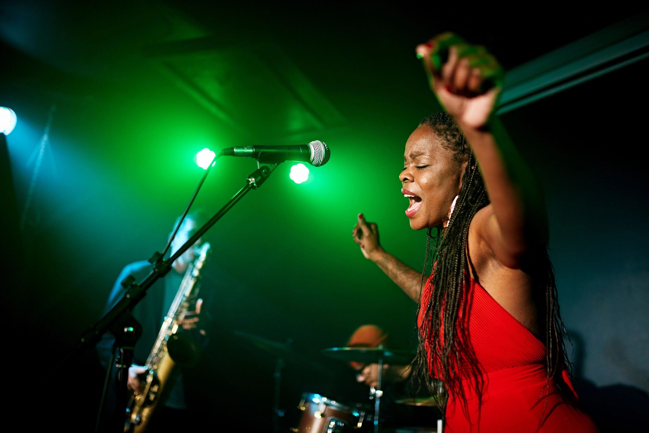Singer performing live with band in a club setting